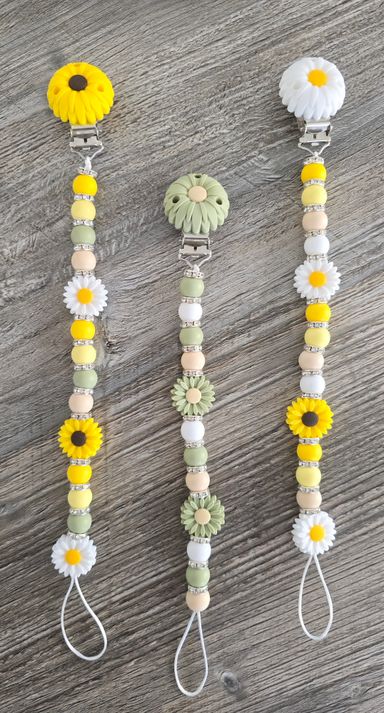 SchnullerKettemitGlitzerBabygeschenkSilikonmitKlippSonnenblumenGelbund LindgrünEvent-Shop-Hameln